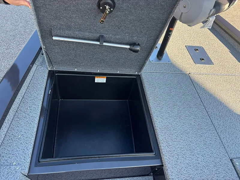 Slide: The Image of 2025 G3 Sportsman 1710 boat storage compartment with open lid and key lock. - 14