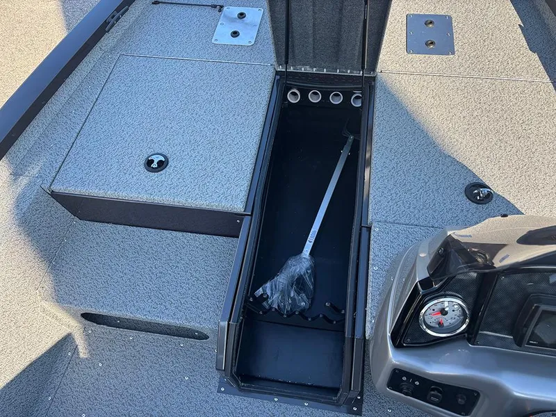 Slide: The Image of 2025 G3 Sportsman 1710 boat interior with open storage compartment and steering console. - 15
