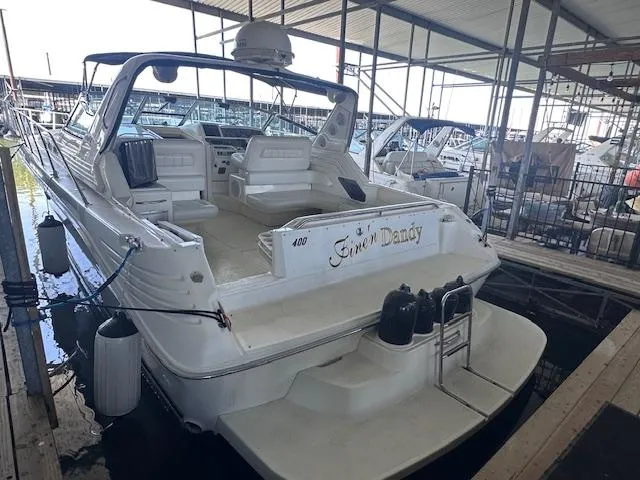 The Image of 1996 Sea Ray 400 EXPRESS yacht docked in marina, rear view. - 0