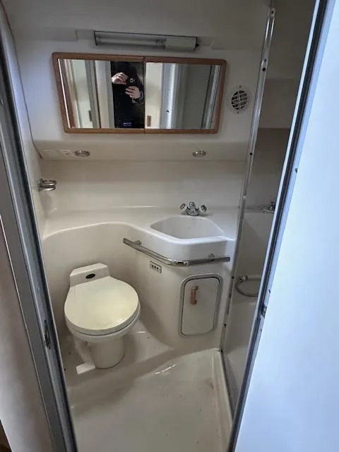 Slide: The Image of Bathroom interior of 1996 Sea Ray 400 EXPRESS yacht, featuring toilet and sink. - 16