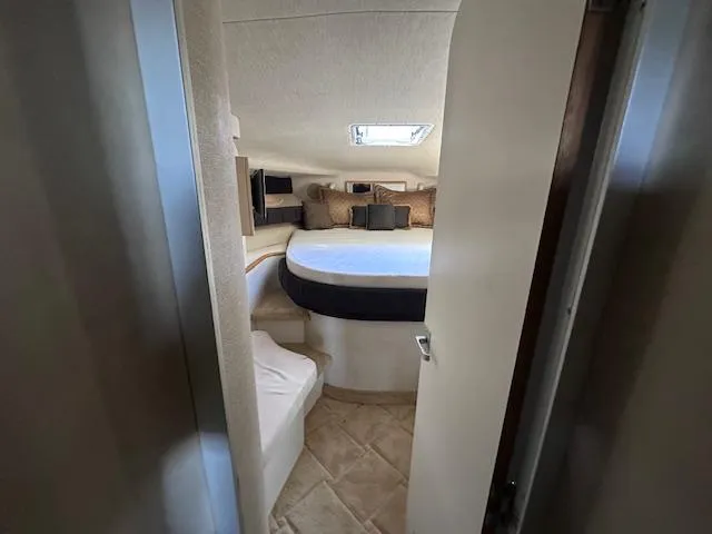 Slide: The Image of Interior cabin of 1996 Sea Ray 400 EXPRESS yacht, featuring a cozy bed and seating area. - 18