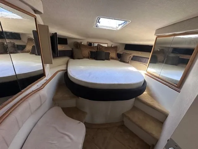 Slide: The Image of 1996 Sea Ray 400 EXPRESS cabin interior with bed, mirrors, and seating. - 19