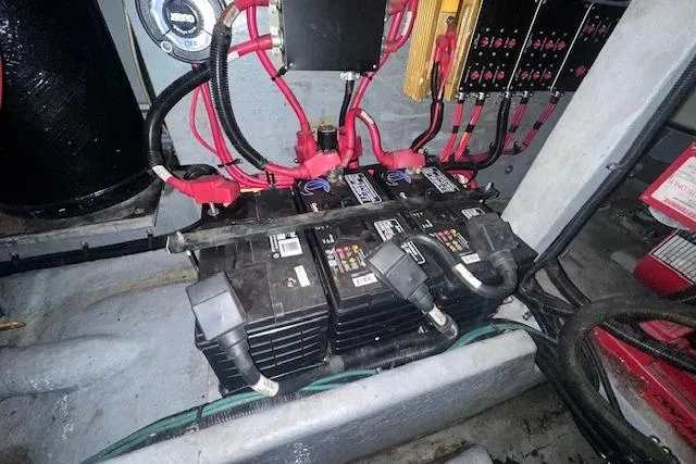 Slide: The Image of Battery compartment of a 1996 Sea Ray 400 Express Cruiser with wiring and connections. - 27