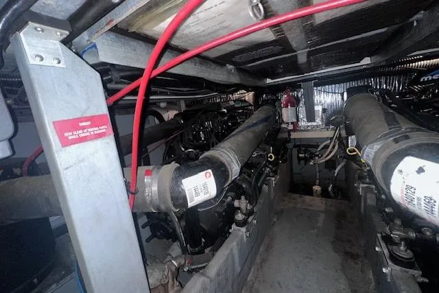 Slide: The Image of Engine room of a 1996 Sea Ray 400 Express Cruiser, showcasing mechanical components. - 28