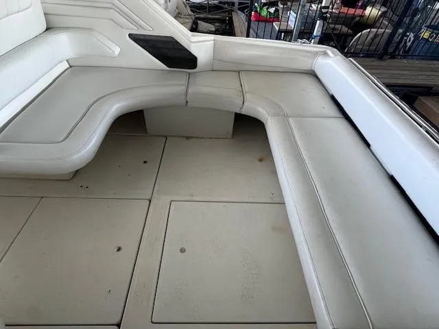 Slide: The Image of Interior seating area of a 1996 Sea Ray 400 EXPRESS boat, featuring white cushioned seats. - 6