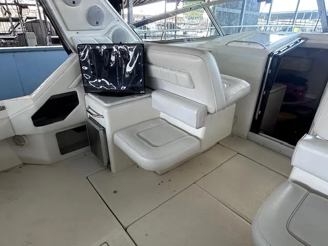 Slide: The Image of 1996 Sea Ray 400 EXPRESS interior with white seating and modern amenities. - 7