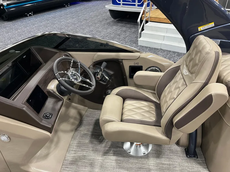 Slide: The Image of 2025 Bennington Q Line boat interior with luxurious captain's chair and modern dashboard. - 6