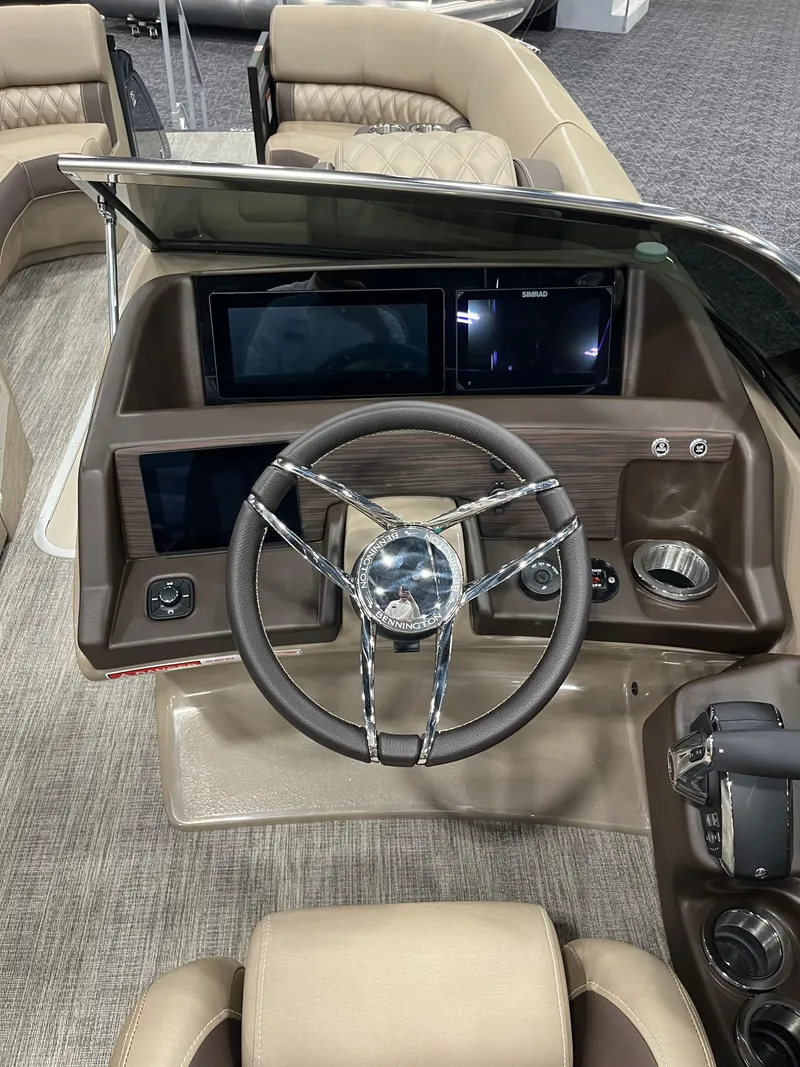 Slide: The Image of 2025 Bennington Q Line boat dashboard with modern steering wheel and digital displays. - 7