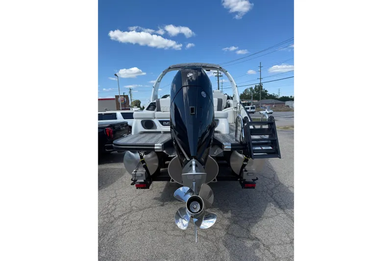 Slide: The Image of 2025 Bennington R Line boat with powerful outboard motor and sleek design. - 13