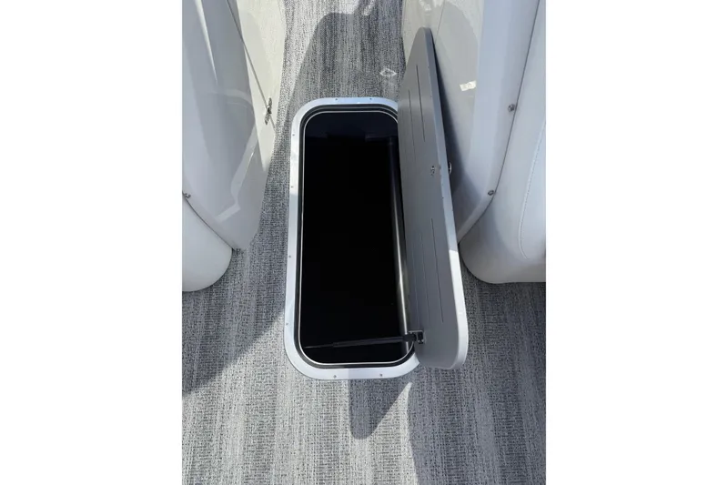 Slide: The Image of Open storage compartment on 2025 Bennington R Line boat, featuring sleek design and modern finish. - 17