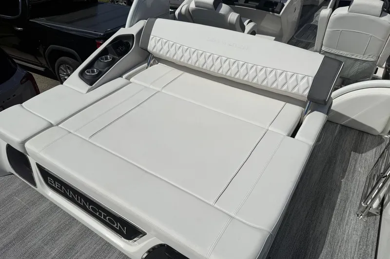 Slide: The Image of 2025 Bennington R Line boat with luxurious white seating and cup holders. - 19