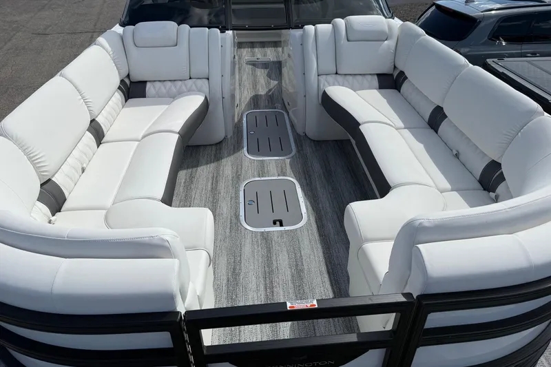 Slide: The Image of 2025 Bennington R Line boat interior with luxurious white seating and modern design. - 22