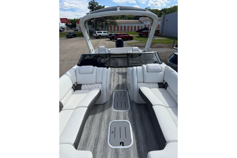 Slide: The Image of 2025 Bennington R Line boat interior with luxurious white seating and modern design. - 3