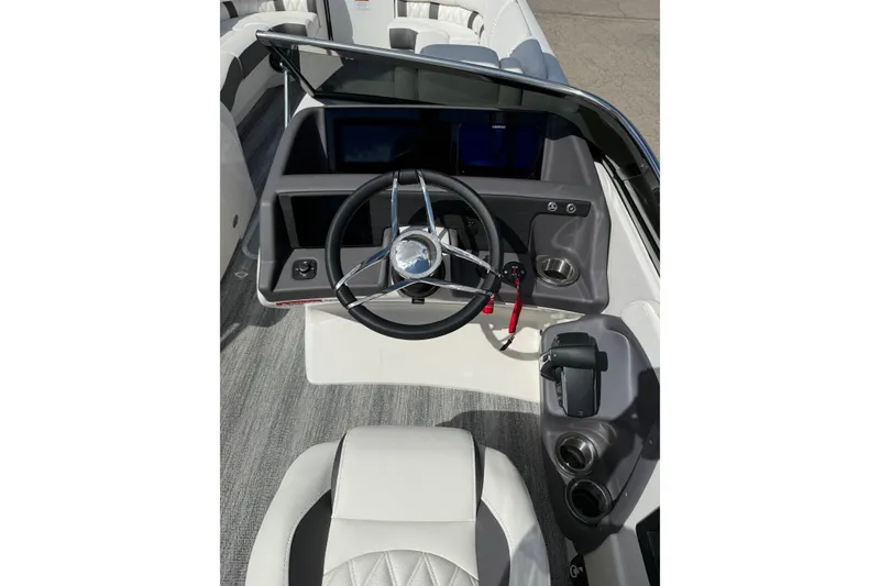 Slide: The Image of 2025 Bennington R Line boat cockpit with steering wheel and control panel. - 9