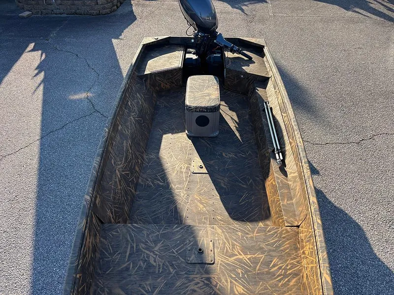 Slide: The Image of 2025 G3 Gator Tough 16 FL boat interior with camouflage design and motor. - 11