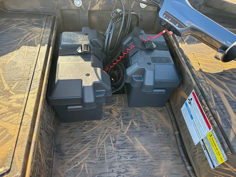 Slide: The Image of 2025 G3 Gator Tough 16 FL boat interior with battery compartments and wiring. - 18