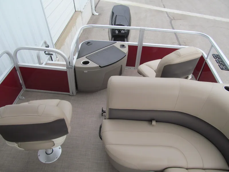 Slide: The Image of 2022 Sun Tracker Bass Buggy 18 DLX interior with beige seating and red accents. - 11