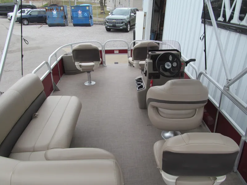 Slide: The Image of 2022 Sun Tracker Bass Buggy 18 DLX pontoon boat interior with beige seating. - 4