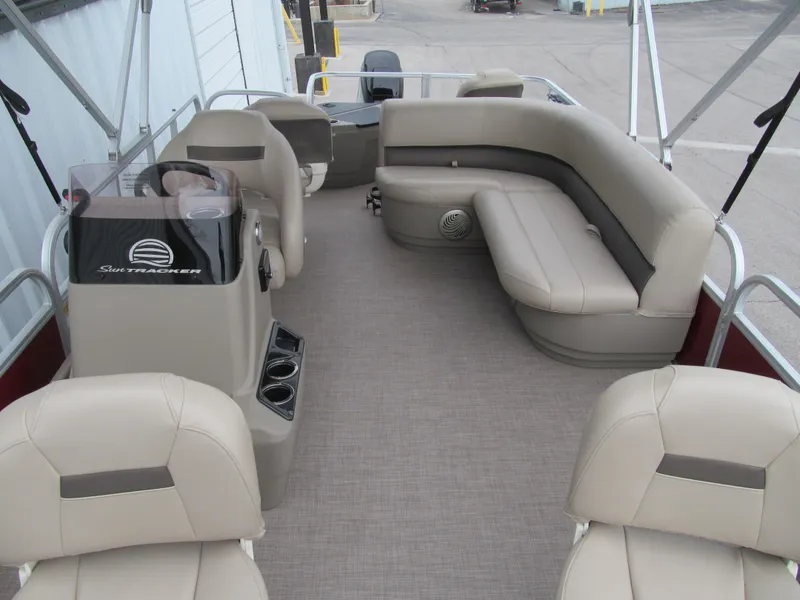 Slide: The Image of 2022 Sun Tracker Bass Buggy 18 DLX pontoon boat interior with beige seating. - 9