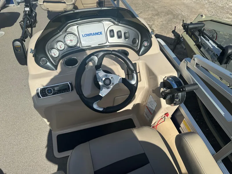 Slide: The Image of 2017 Sun Tracker Fishin' Barge 22 DLX dashboard with steering wheel and Lowrance display. - 10