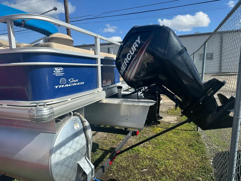 Slide: The Image of 2017 Sun Tracker Fishin' Barge 22 DLX with Mercury outboard motor, parked outdoors. - 3