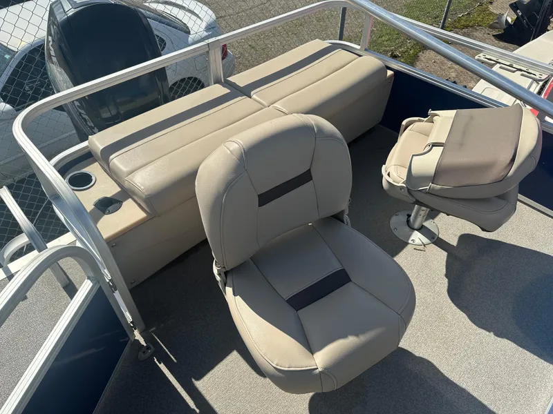 Slide: The Image of 2017 Sun Tracker Fishin' Barge 22 DLX interior with beige seating and cup holders. - 7