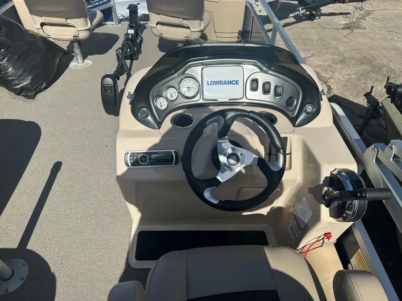 Slide: The Image of 2017 Sun Tracker Fishin' Barge 22 DLX dashboard with steering wheel and Lowrance display. - 9