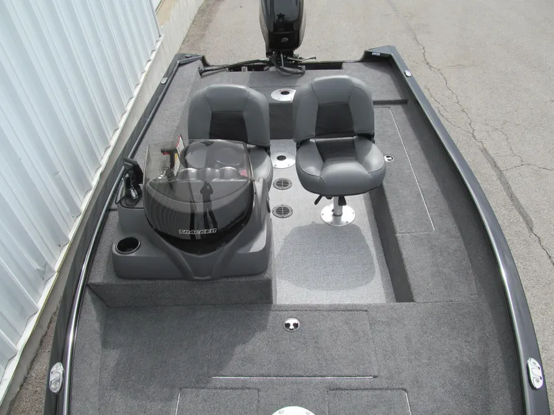 Slide: The Image of 2024 Tracker Super Guide V-16 SC boat interior with dual seats and steering console. - 12