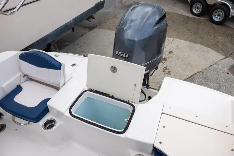 Slide: The Image of 2019 Robalo R180 Center Console boat with Yamaha 150 engine and open storage compartment. - 13
