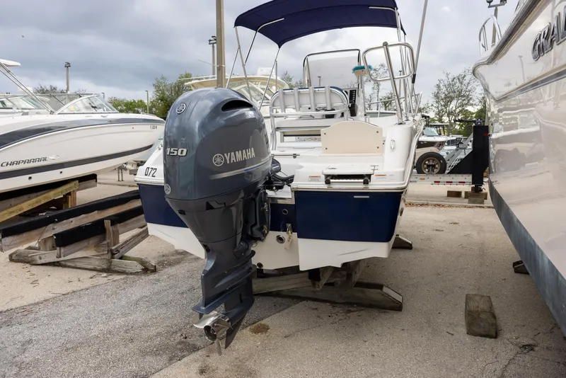 Slide: The Image of 2019 Robalo R180 Center Console boat with Yamaha engine, docked outdoors. - 2