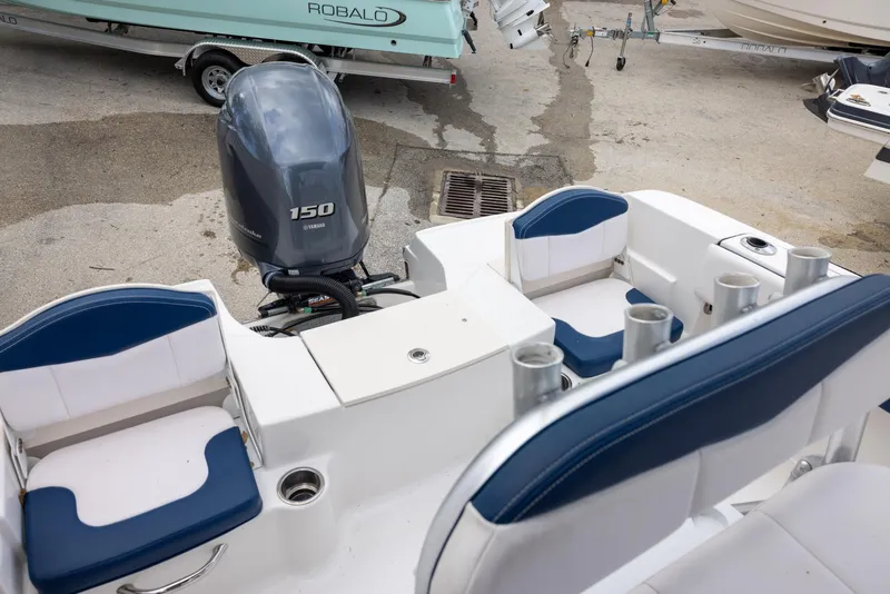 Slide: The Image of 2019 Robalo R180 Center Console boat with Yamaha 150 engine, featuring blue and white seating. - 6