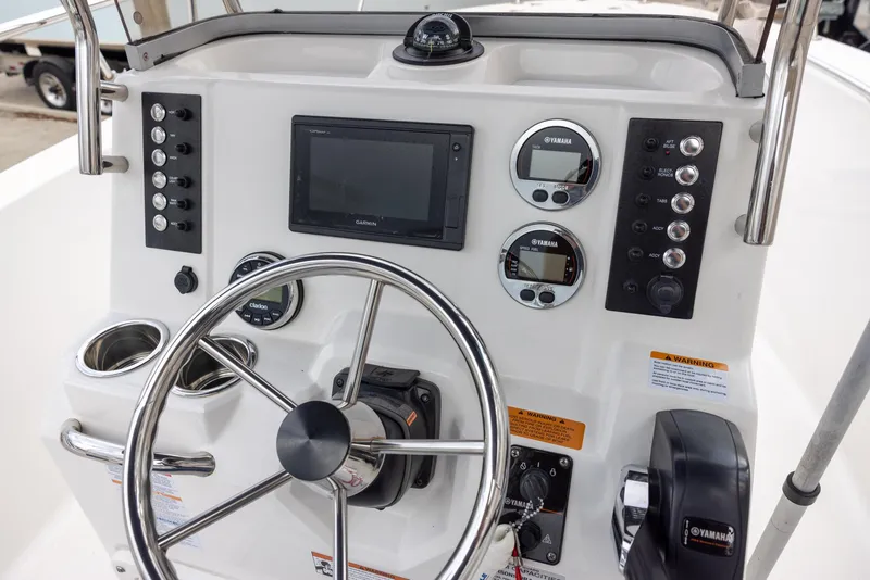 Slide: The Image of 2019 Robalo R180 Center Console dashboard with steering wheel and electronic controls. - 7