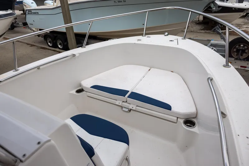 Slide: The Image of 2019 Robalo R180 Center Console boat with cushioned seating area. - 9