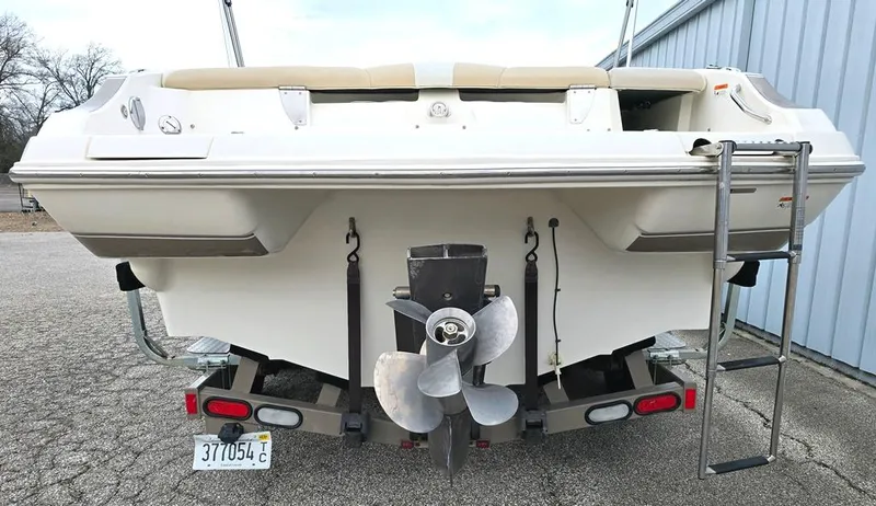 Slide: The Image of 2006 Larson LXI 268 BR boat rear view with propeller and ladder. - 12