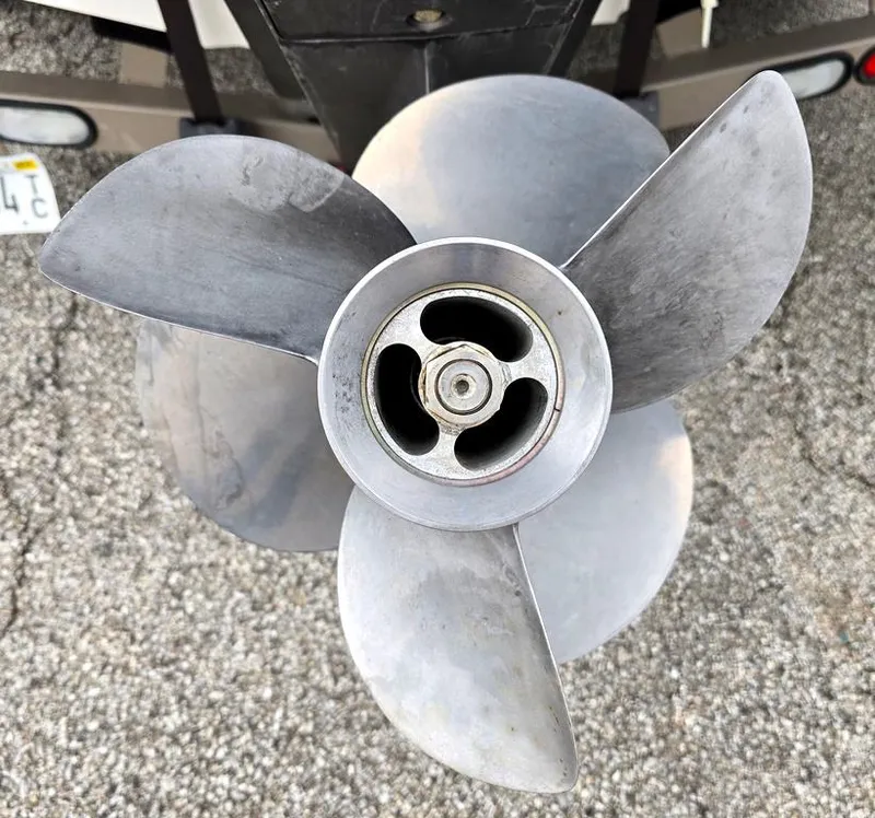 Slide: The Image of Close-up of a 2006 Larson LXI 268 BR boat propeller on a textured surface. - 14