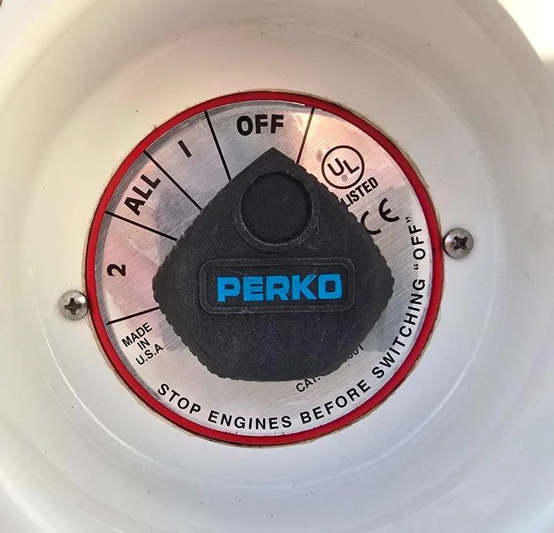 Slide: The Image of Perko battery switch on 2006 Larson LXI 268 BR boat, labeled "Stop engines before switching off." - 20