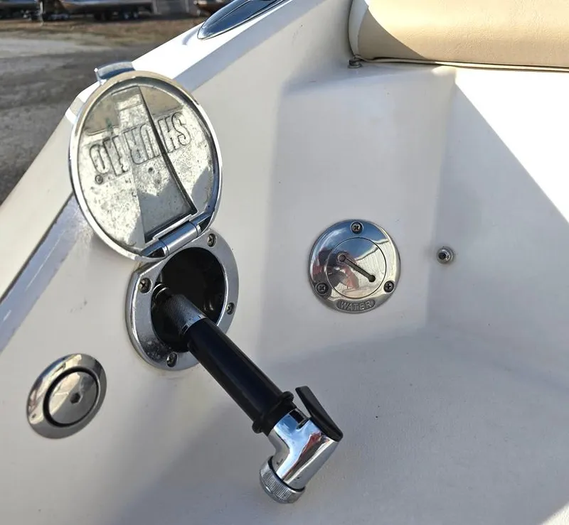 Slide: The Image of 2006 Larson LXI 268 BR boat fuel cap and water inlet detail. - 21