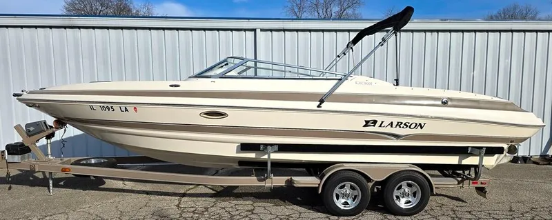 Slide: The Image of 2006 Larson LXI 268 BR boat on trailer, parked outdoors. - 22