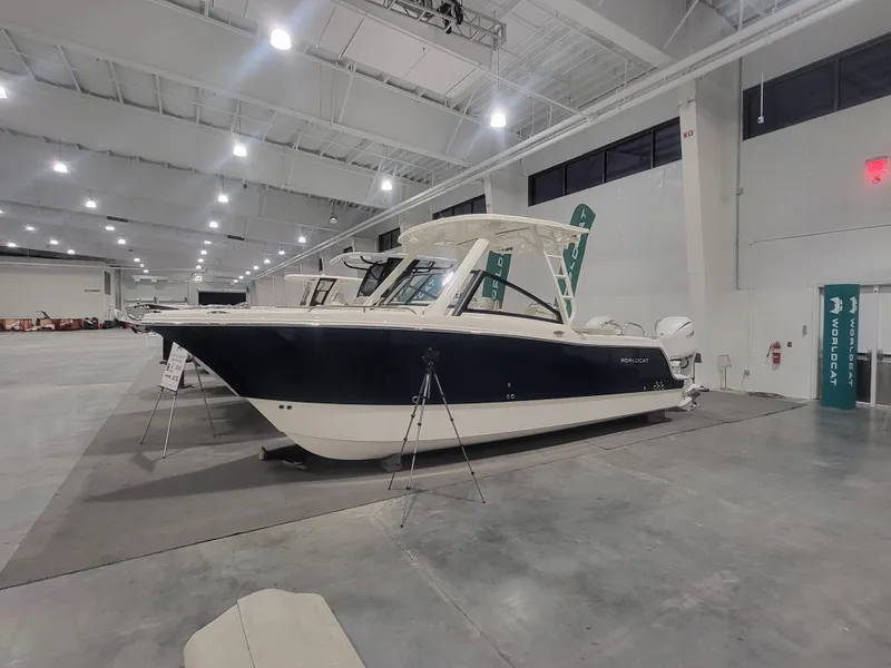 The Image of 2025 World Cat 260 DC-X boat displayed in a spacious indoor showroom. - 0