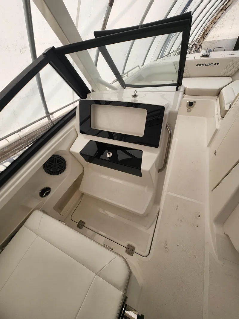 Slide: The Image of 2025 World Cat 260 DC-X boat interior with sleek seating and modern dashboard design. - 11