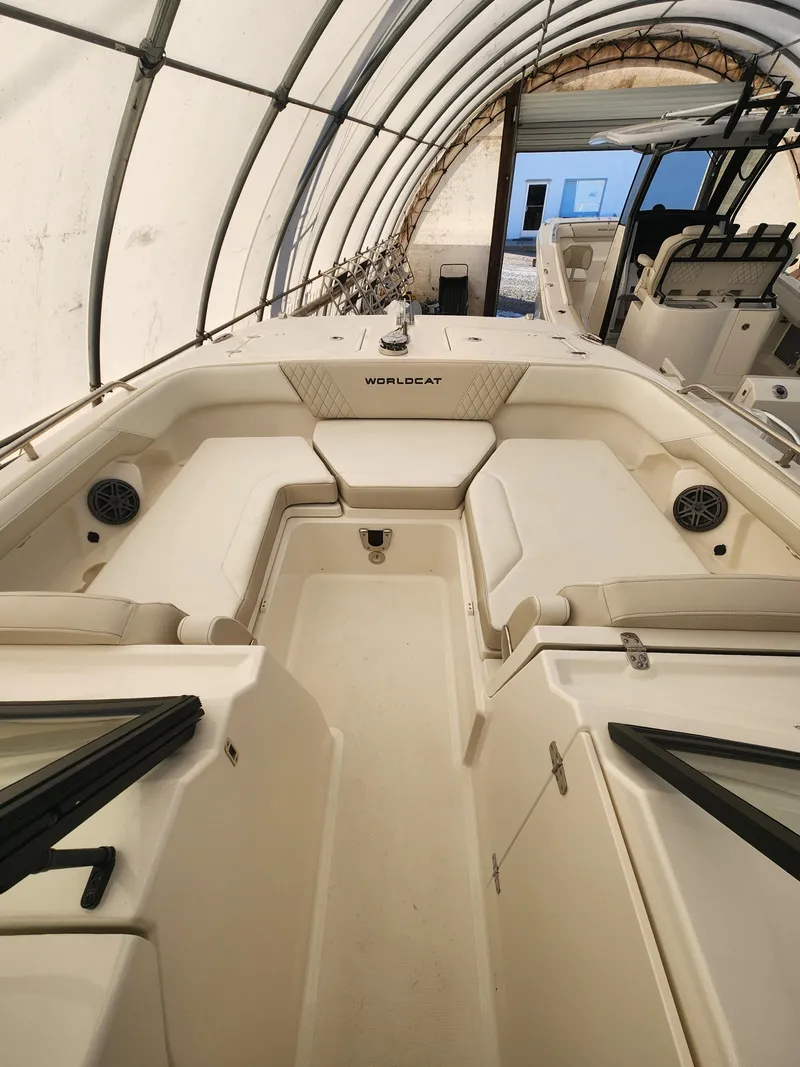Slide: The Image of 2025 World Cat 260 DC-X boat interior under a canopy, showcasing seating and storage. - 3