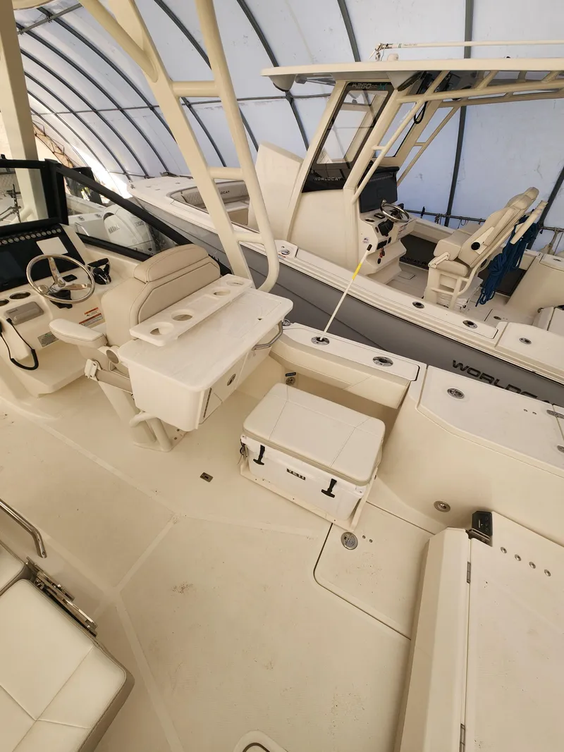 Slide: The Image of 2025 World Cat 260 DC-X boat interior with seating and helm under a canopy. - 6