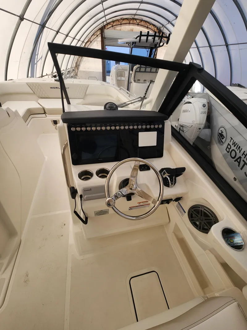Slide: The Image of 2025 World Cat 260 DC-X boat interior with steering wheel and control panel. - 7