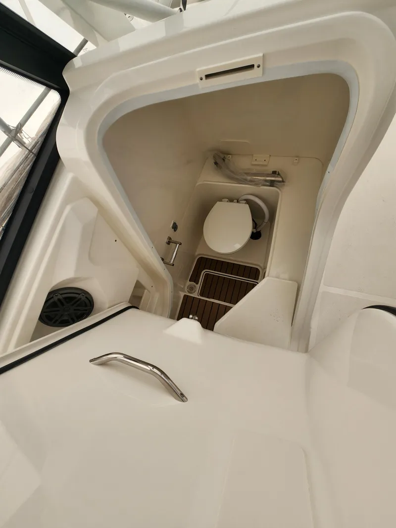 Slide: The Image of 2025 World Cat 260 DC-X boat interior with compact marine toilet. - 8