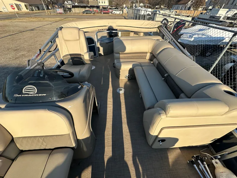 Slide: The Image of 2023 Sun Tracker Fishin' Barge 20 DLX interior with beige seating and spacious layout. - 12
