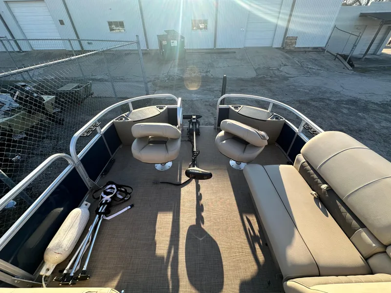 Slide: The Image of 2023 Sun Tracker Fishin' Barge 20 DLX interior with seating and fishing gear. - 14
