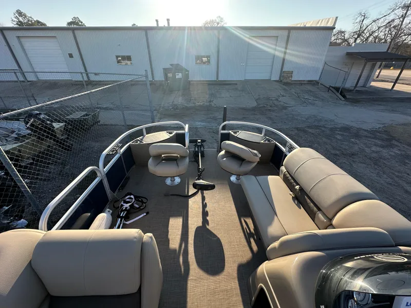Slide: The Image of 2023 Sun Tracker Fishin' Barge 20 DLX interior with seating and fishing setup. - 15