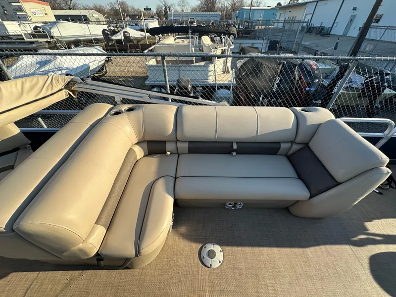Slide: The Image of 2023 Sun Tracker Fishin' Barge 20 DLX with beige seating, docked in a marina. - 16