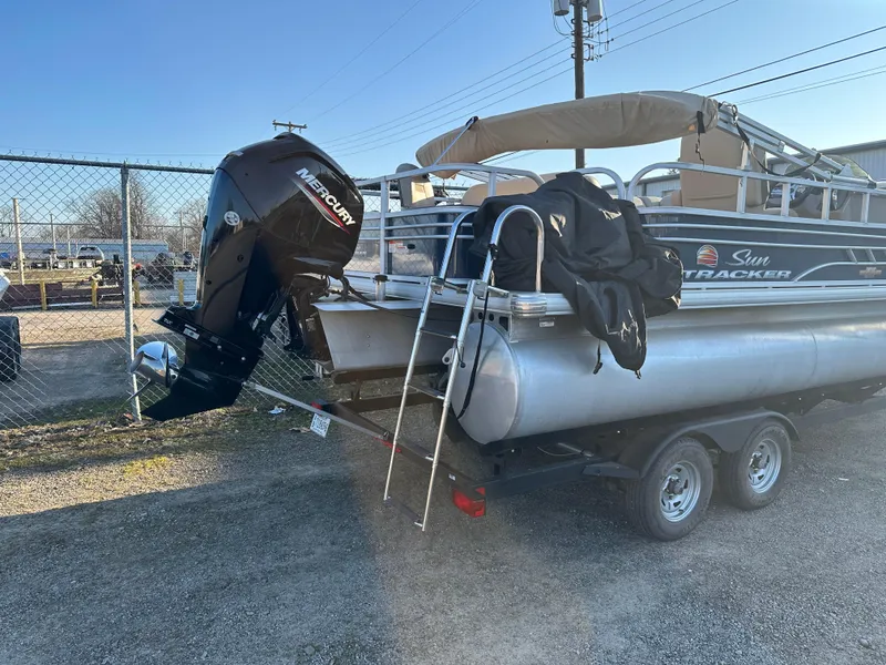 Slide: The Image of 2023 Sun Tracker Fishin' Barge 20 DLX pontoon boat on trailer with Mercury outboard motor. - 3