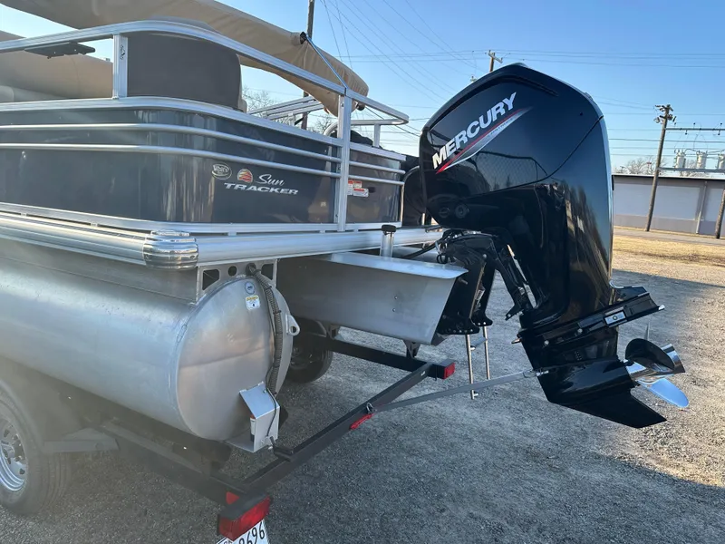 Slide: The Image of 2023 Sun Tracker Fishin' Barge 20 DLX with Mercury outboard motor, parked on a trailer. - 5